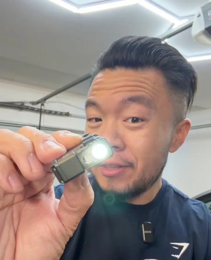 Gavin presenting a compact flashlight close to camera