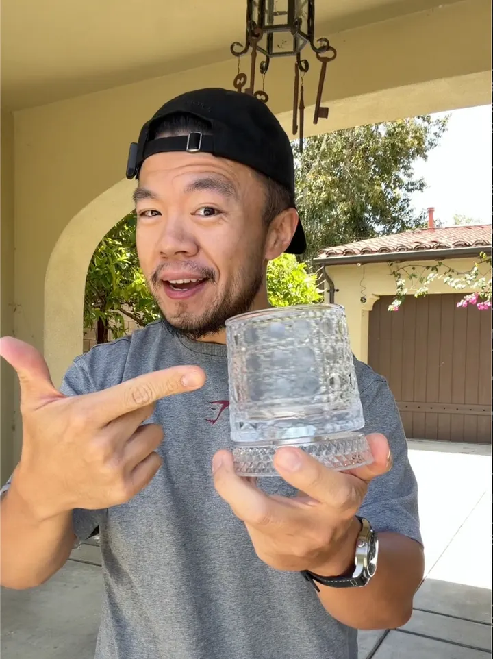 Gavin presenting a drinking glass outdoors