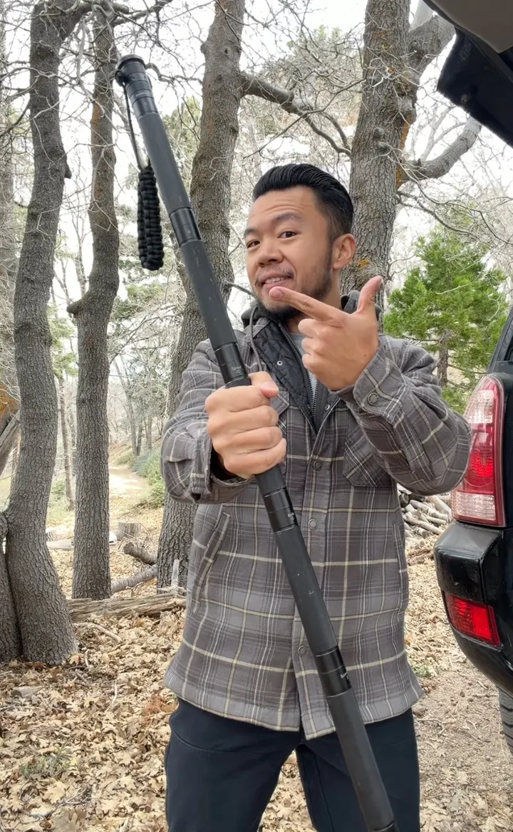 Gavin demonstrating a hiking product in the woods